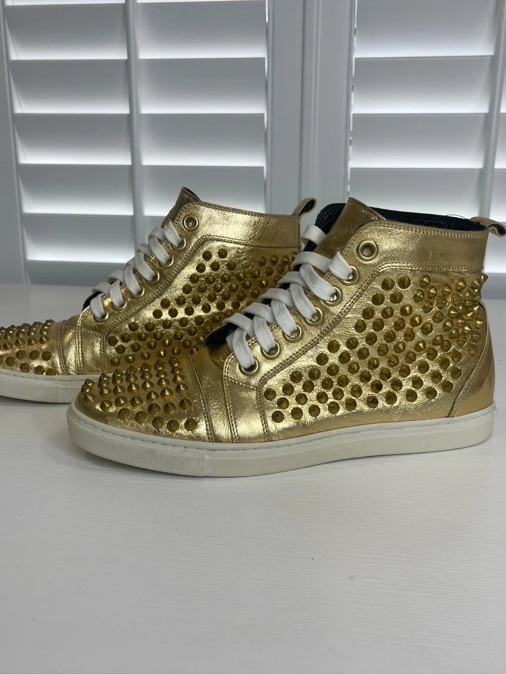 Metallic Gold High-Top Sneakers with Stud Details by Rodney P. Hunt